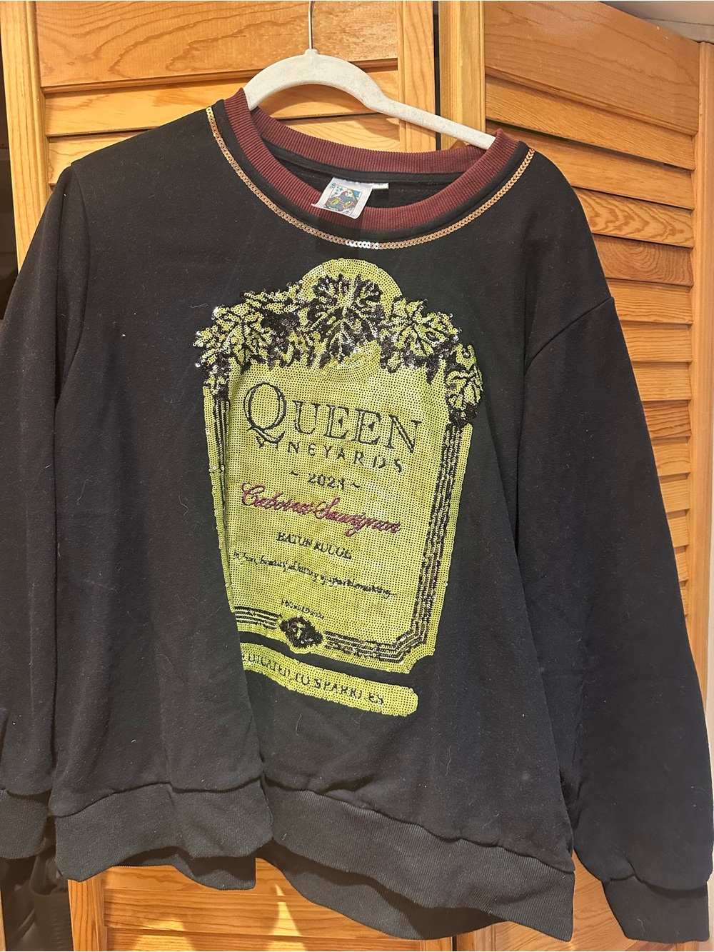 QUEEN OF SPARKLES Black Sweatshirt with Yellow-Green Label Graphic